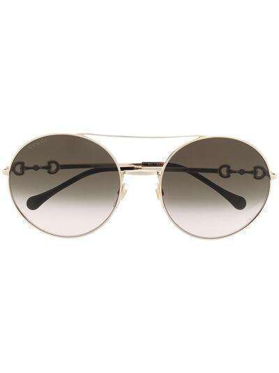 Gucci Eyewear солнцезащитные очки в круглой оправе с декором Horsebit